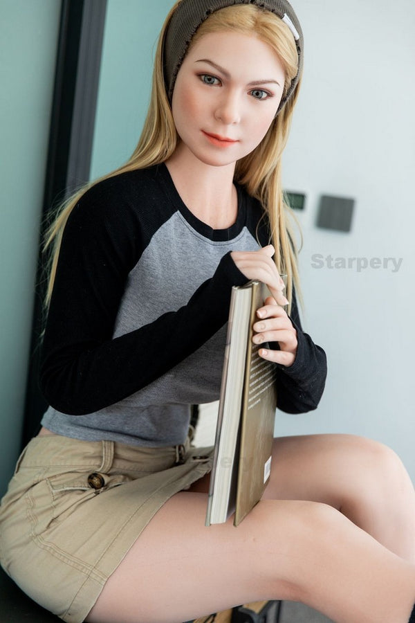 Imogen seated while holding a closed book