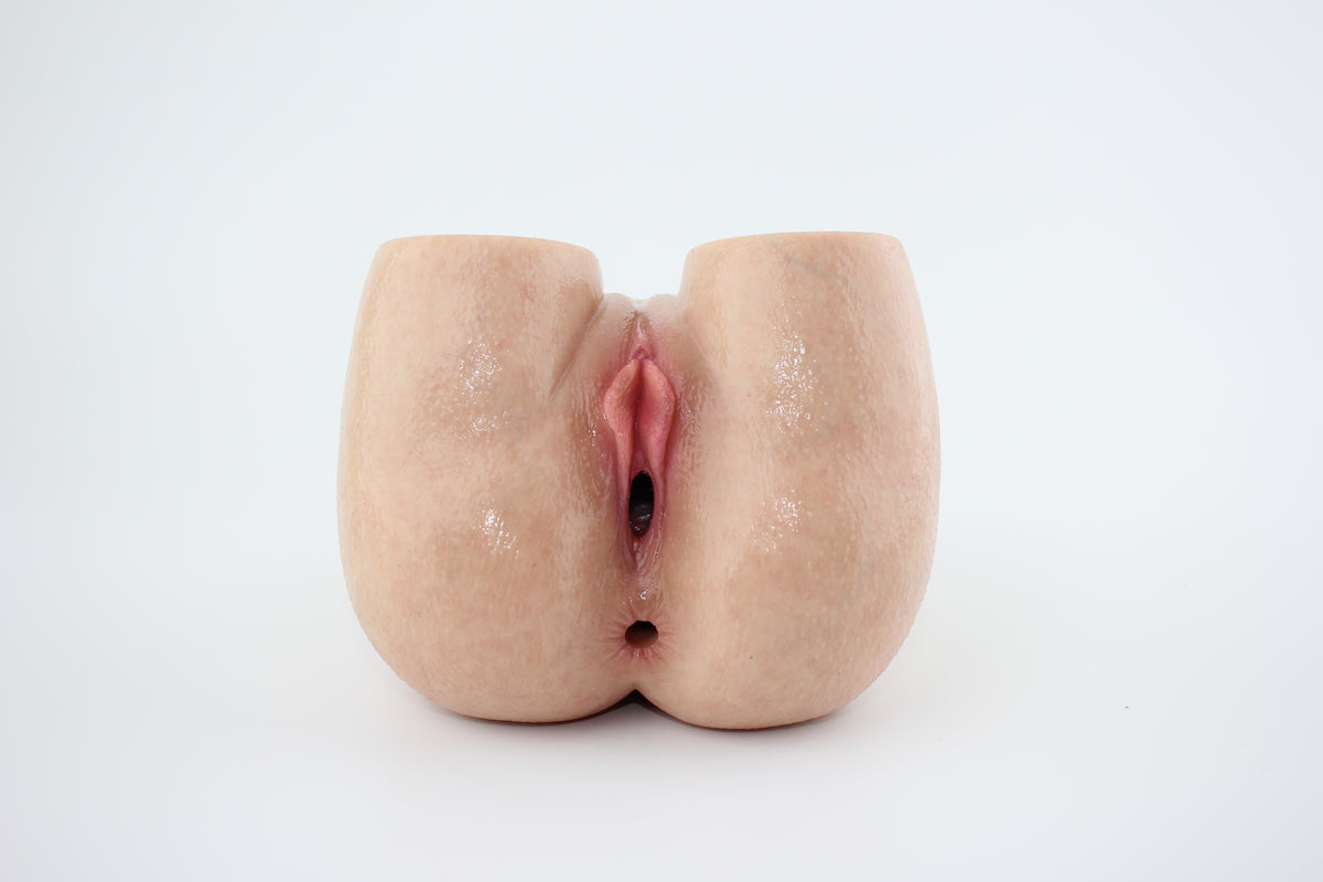 Peach-shaped silicone lower-body torso on a white background
