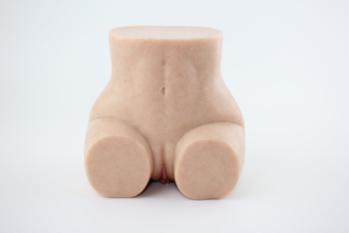 Upright front view of peach-shaped silicone lower torso