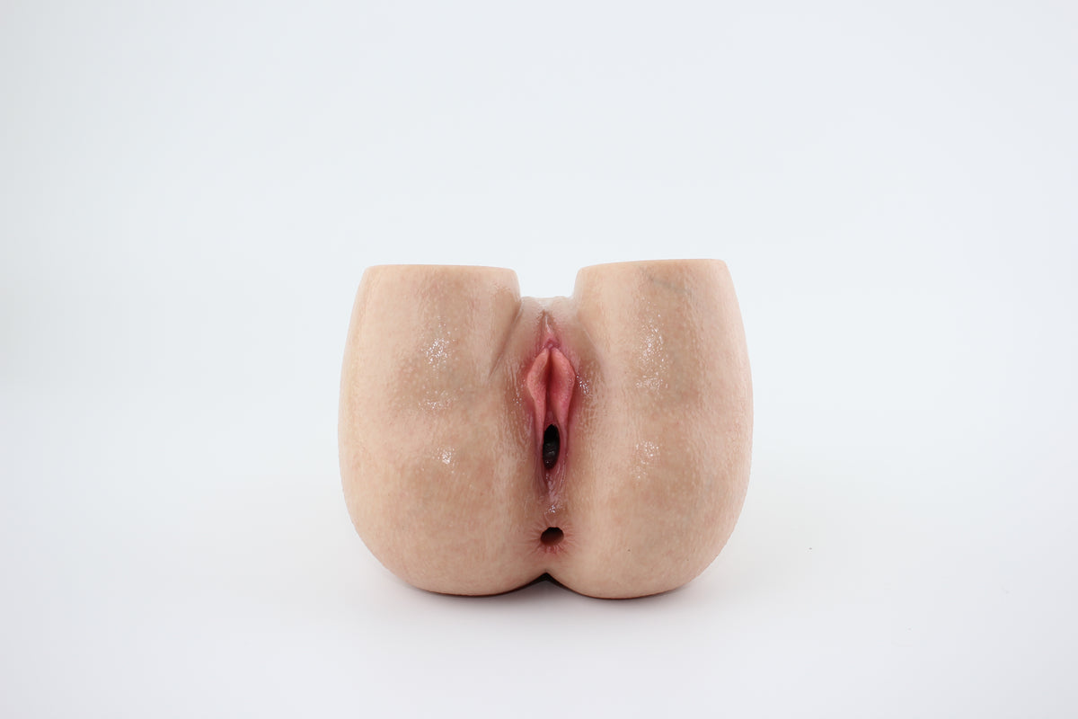 Wide front view of peach-shaped silicone torso