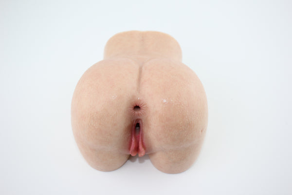Elevated rear view of peach-shaped silicone torso