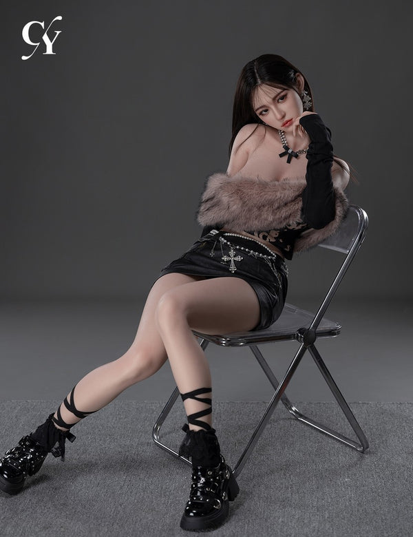 Zhimin reclining sideways on a metal chair