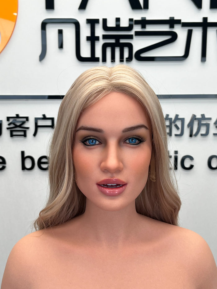 A close-up of the face and shoulders of a blonde silicone female doll, showcasing the makeup and head sculpt.