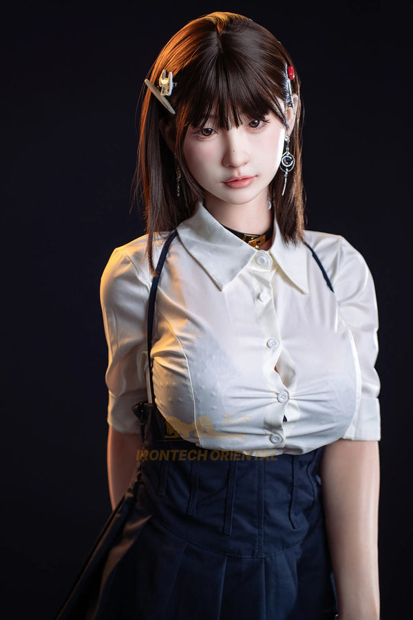 A 1/6 scale collectible action figure of a young woman with brown hair, wearing a white short-sleeve button-up shirt and dark blue denim overalls, posed against a solid black background.