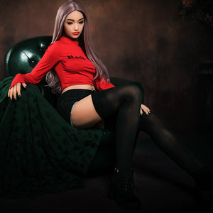 a woman sitting on top of a green field 