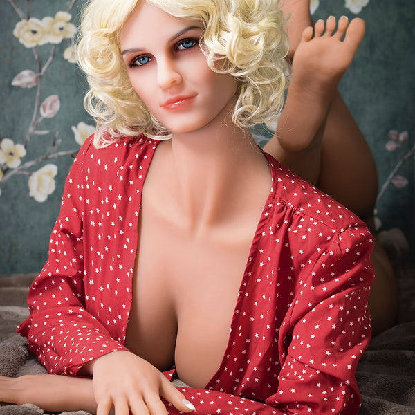 a woman in a red dress sitting on a bed 